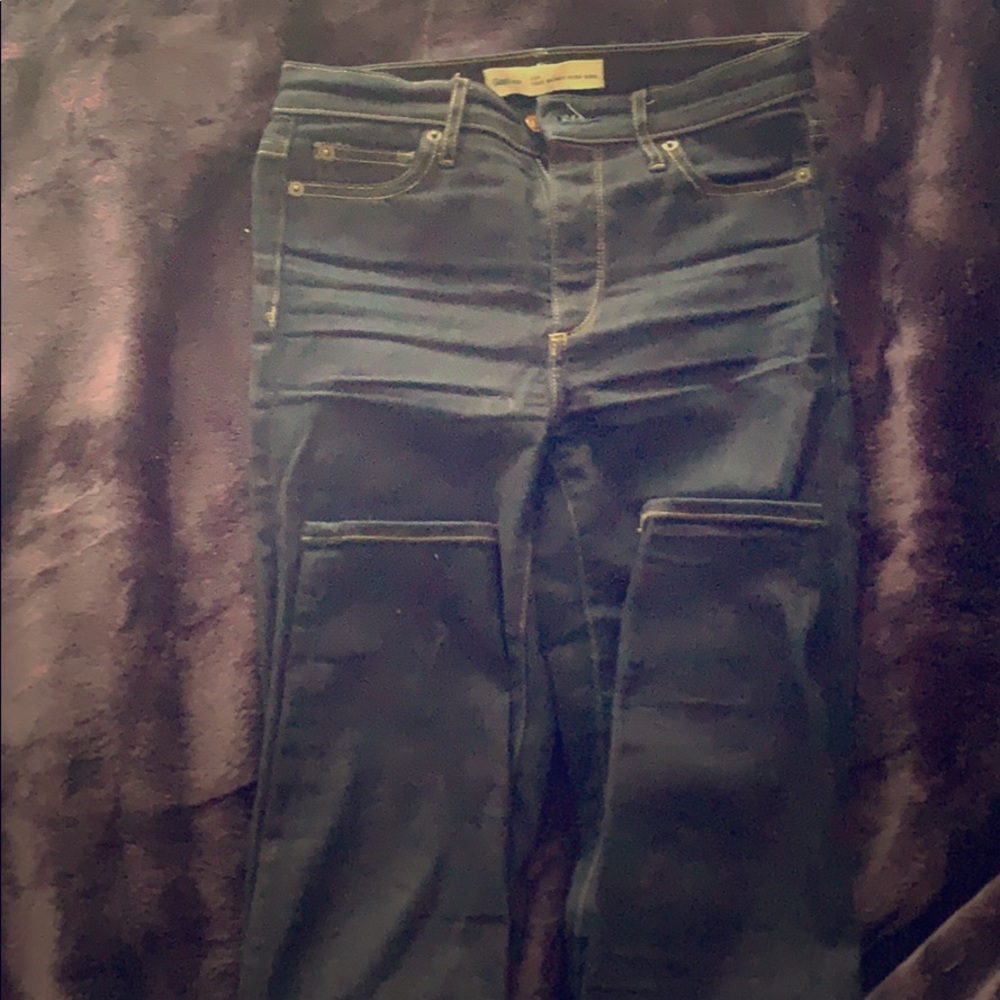 This is a dark wash skinny high rise jean.